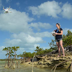 North Carolina State University researcher Enie Hensel with a drone at a research site in The Bahamas.