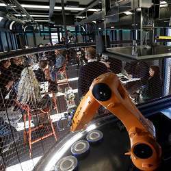 The robotic arm (foreground, in orange) of a robotic bartender in Prague, Czech Republic. 