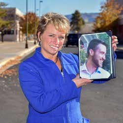 Theresa Rolfe of Sandia holding photo of her son