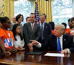 U.S. President Donald Trump speaks to students in the Oval Office of the White House.