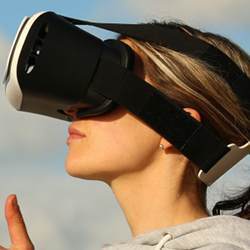 A woman using a virtual reality headset.