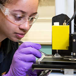 Doctoral candidate Monique McClain demonstrates the three-dimensional printing of extremely viscous materials. 