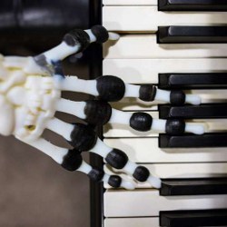 robotic hand on piano keys