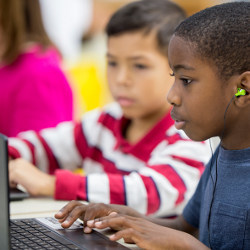 grade school students at computer