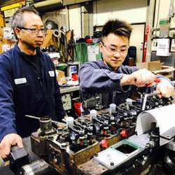 An apprentice learns mechanical repair.