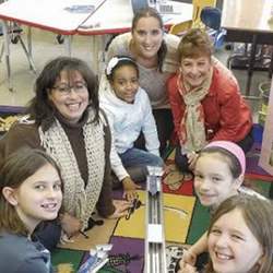 Teachers at an elementary school in Stony Point, NY, help students building a robot.