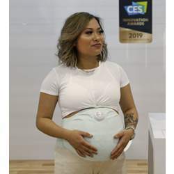 A woman models the Owlet Band pregnancy monitor.