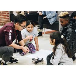 Robotics and Coding Academy students work with their USC student mentor.