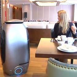 Interacting with a robot in the hotel's dining room.