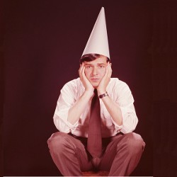 man wearing dunce cap