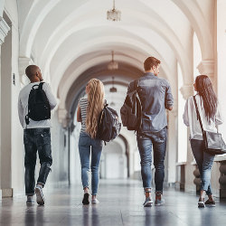 group of students walking in university hall