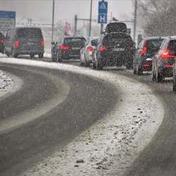 Traffic backing up on a snowy road.