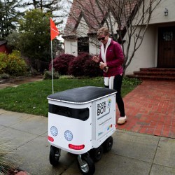 Mountain View resident returns a book using the BookBot device