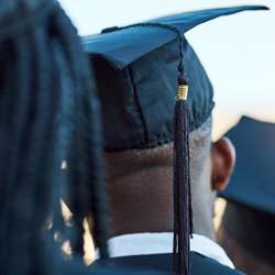 Rearview shot of a group of students standing on graduation day.