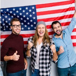 joyful students standing with U.S. flag