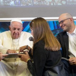 Pope Francis helps write a line of code as Code.org co-founder Hadi Partovi looks on