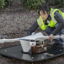 drone operator handling drone that will carry medical specimens 