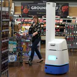 An automated shelf scanner roams a Walmart store.