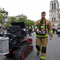 Colossus robot with a firefighter outside Notre Dame 