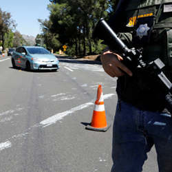 A San Diego County Sheriffs Deputy secures the scene of a shooting at the Congregation Chabad synagogue in Poway, north of San Diego, CA. 