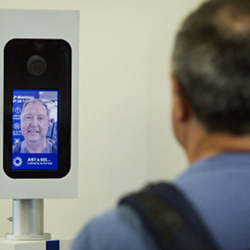 A passenger looks into the camera for a facial recognition test before boarding his flight.