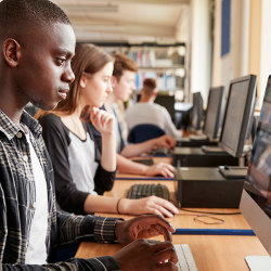 students at computers in library