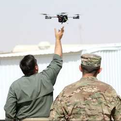 Instructors at the ARCENT Readiness Training Center in Kuwait demonstrate how to launch an aerial drone.