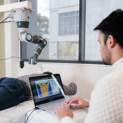 A collaborative robot applies targeted laser therapy to pain hot spots' identified by a thermal camera.