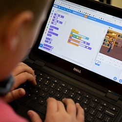 student works on block coding exercise