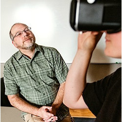 Gonzaga Professor Andrew Goldman observes a student using VR glasses