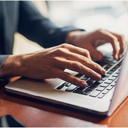 man typing on keyboard