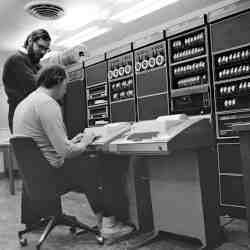  Ken Thompson (sitting) and Dennis Ritchie (standing) in front of a PDP-11.