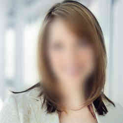 A blurred image of a woman's face.