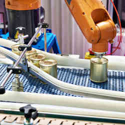 A robot working on a food factory's canning line.