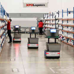 Robots work alongside people at an XPO Logistics facility. 