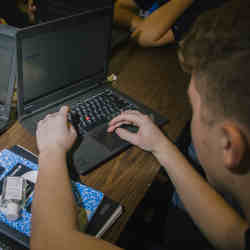 A student participating in a weekly hacking club. 