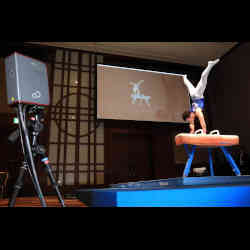 A robot judge uses three-dimensional laser sensors to track the gymnast's movements.