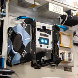 The Astrobee cube robot  Bumble in its docking station onboard the International Space Station 