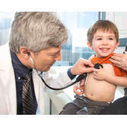 A doctor using a stethoscope to listen to a young boy's chest.