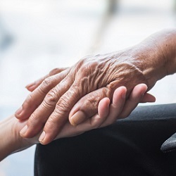 hand of patient and of caregiver