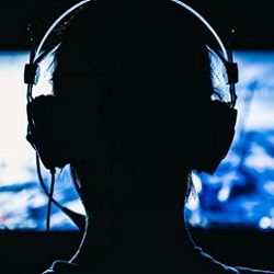 online gamer facing screen and wearing a headset