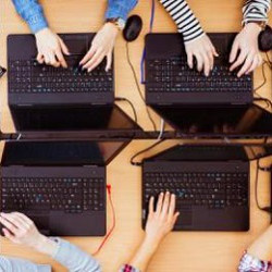 overhead view of students on laptop computers