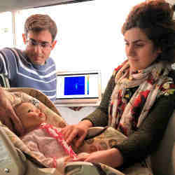Waterloo graduate students Mostafa Alizadeh, left, and Hajar Abedi position a doll in a minivan during testing of the new sensor.
