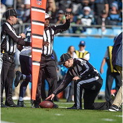 referees making a chain measure in footbal