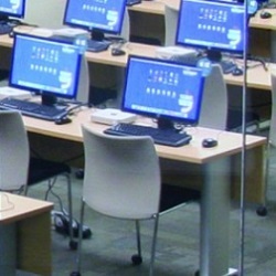 desks with monitors in technology classroom