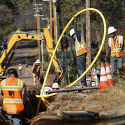 Pacific Gas and Electric workers bury utlility lines in Paradise, CA.