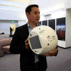 IBM's Bret Greenstein holds a clone of the artificial intelligence bot named CIMON.