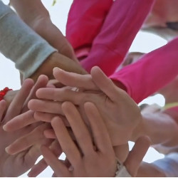 stack of hands showing teamwork