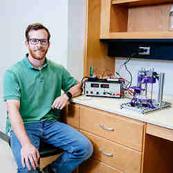 Wesley LaBarge, a UAB Ph.D. candidate in biomedical engineering, with the scaffold-free bioprinter.