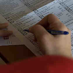 A voter marking a paper ballot.